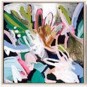 An abstract framed painting featuring expressive brushstrokes in green, pink, white, black, blue, and brown tones, displayed against a clean white wall.